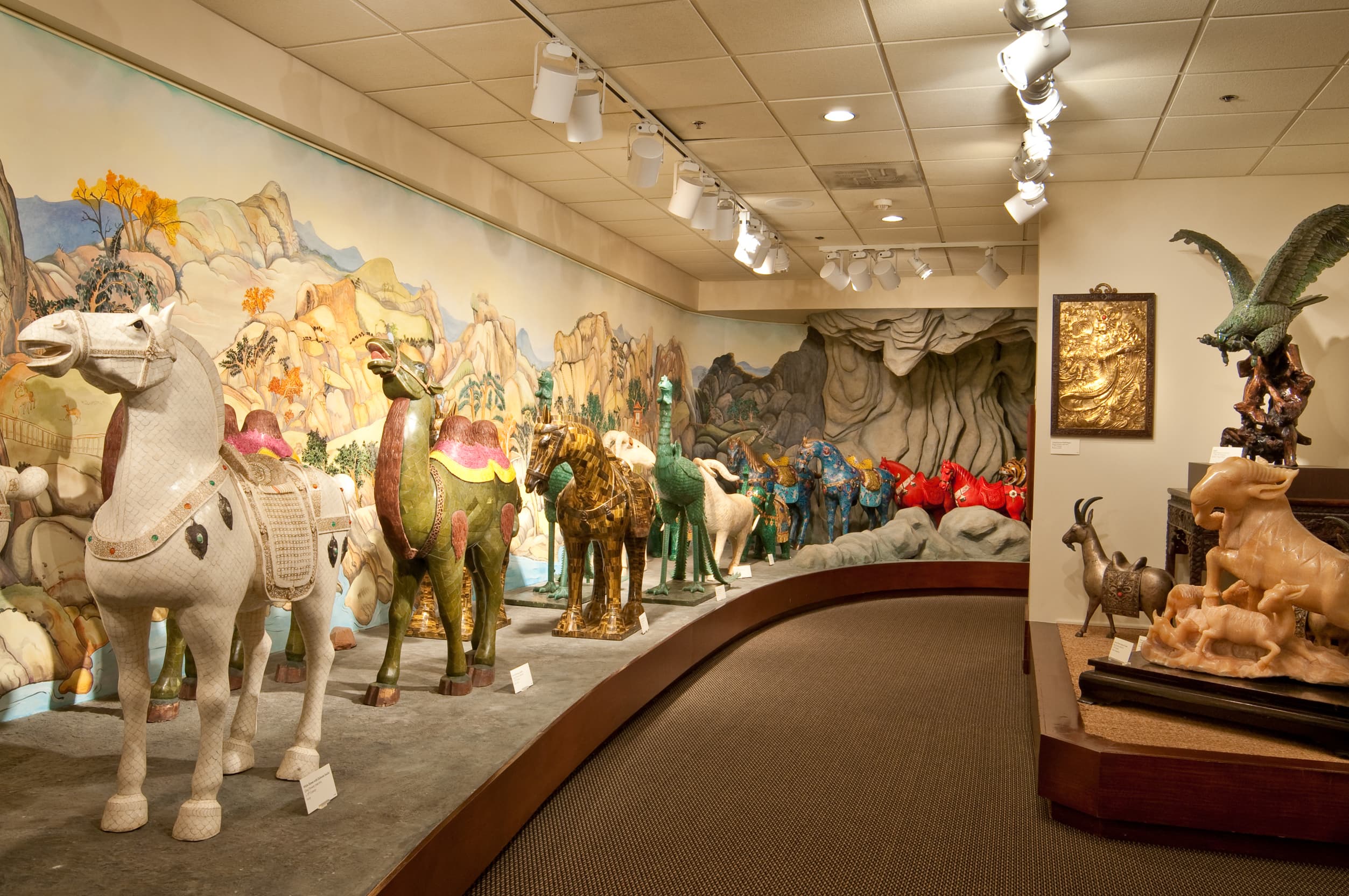 line of jade horses in different colors on display at Belz